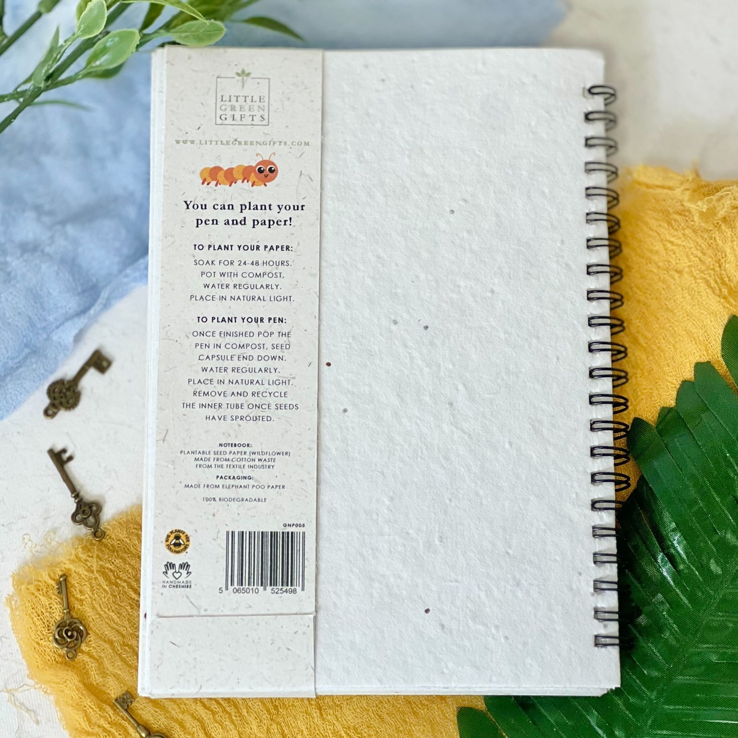 Back of eco-friendly notebook with pen set, fun bugs design