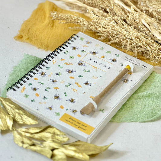 Eco-friendly notebook & pen set with a plantable seed paper cover featuring a bee and flower design.