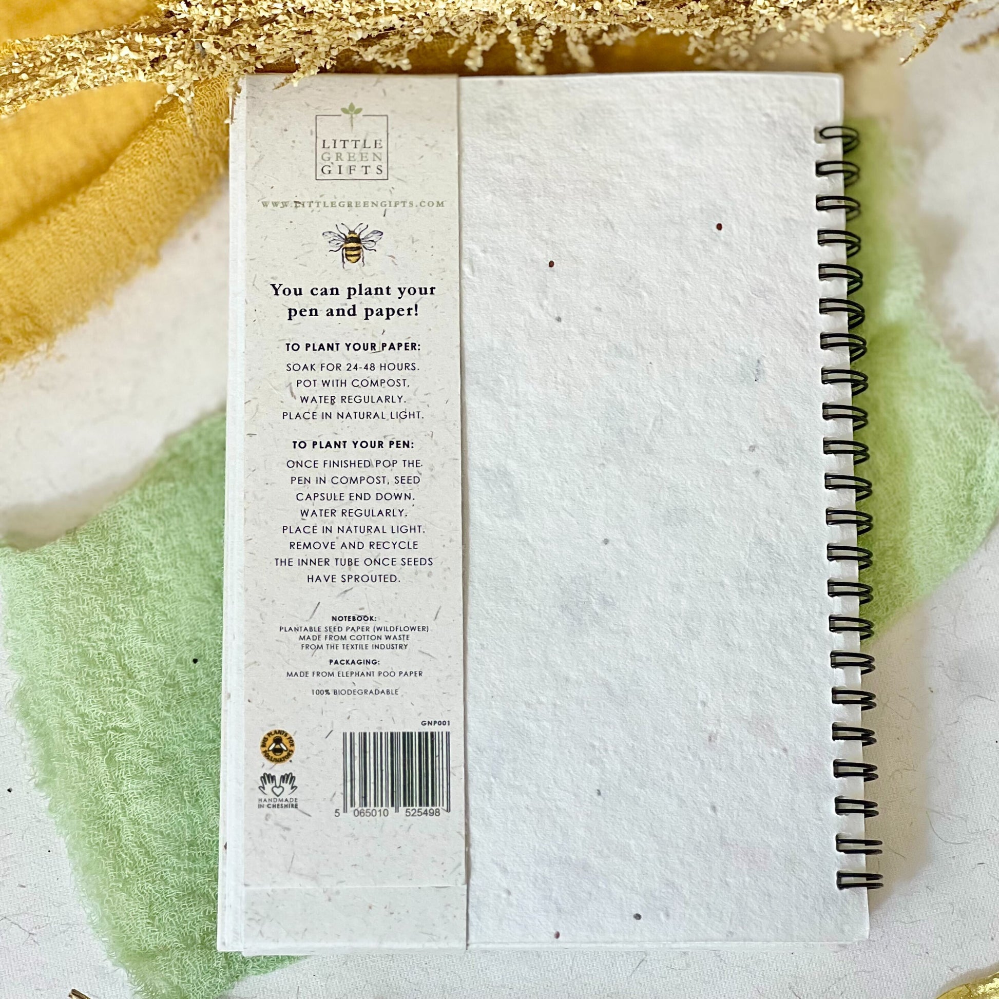 Back of eco-friendly notebook with pen featuring a cute bees and blossoms design