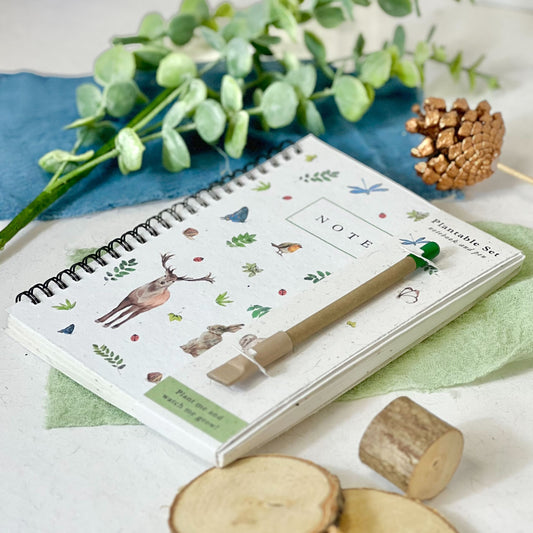Eco-friendly notebook with Woodland Wonders design featuring trees, leaves, and woodland creatures